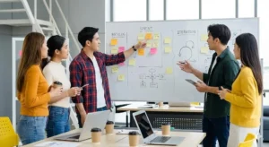 A group of member is discussing on a project on a whiteboard